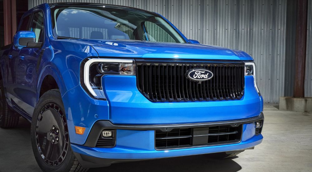 The front end of a blue 2025 Ford Maverick Lobo at a Ford dealer near Barrington.