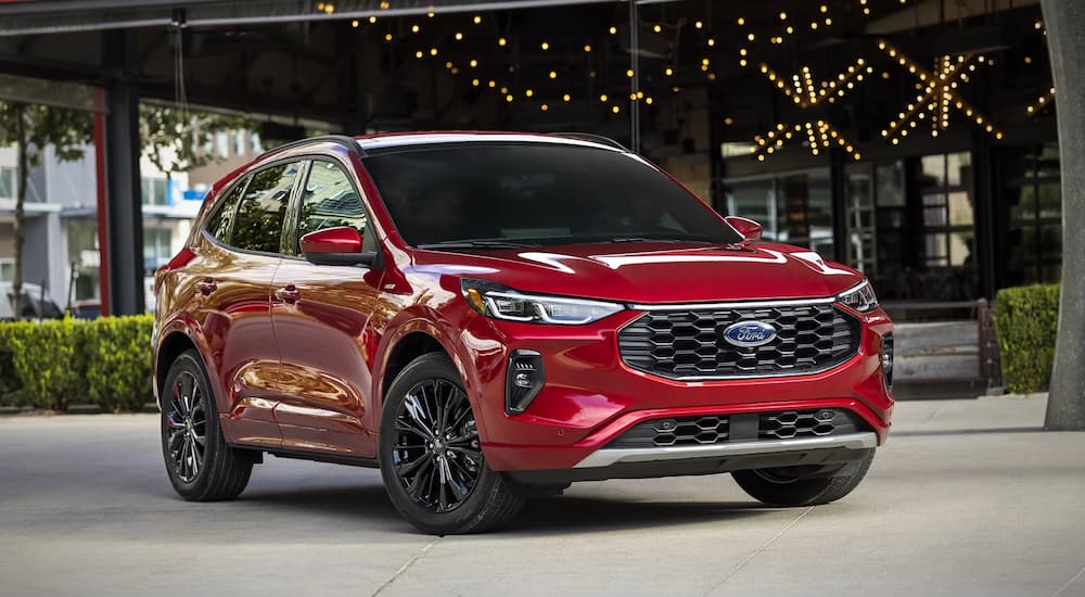 A red 2025 Ford Escape for sale parked outside a building.