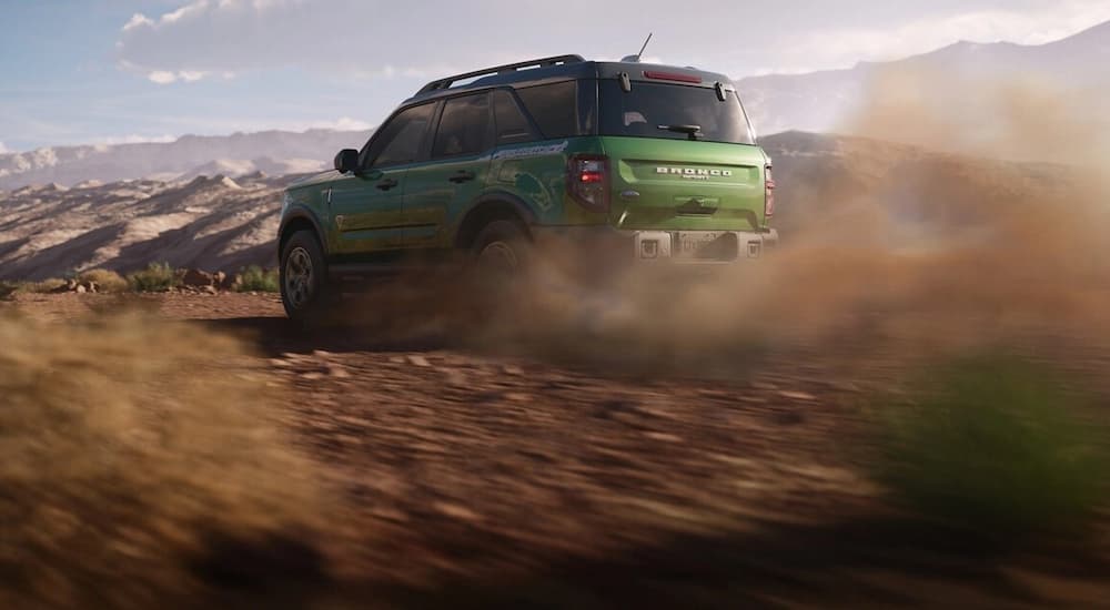 A green 2025 Ford Bronco Sport off-roading on a dirt trail