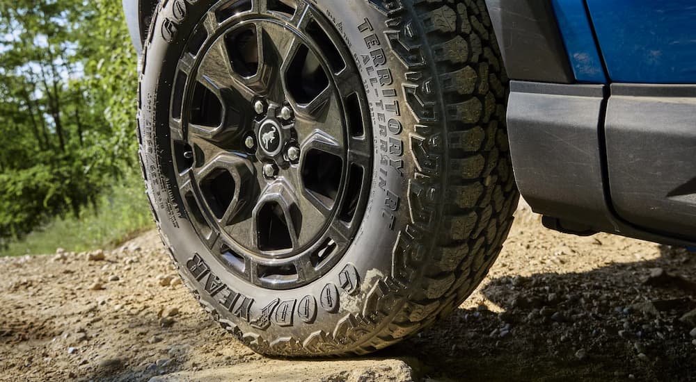 Close-up of the rim and tire on a blue 2025 Ford Bronco Sport