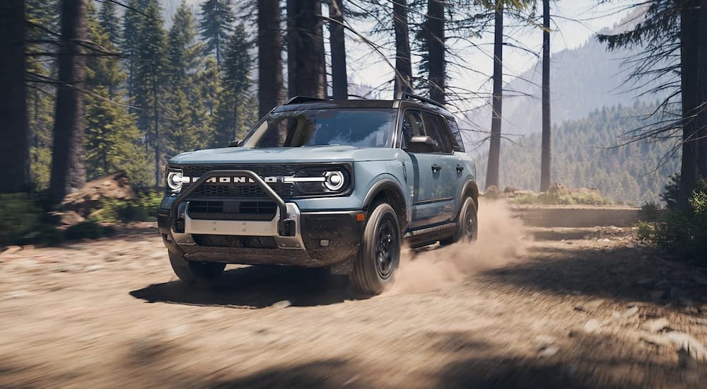 Blue 2025 Ford Bronco Sport driving off-road.