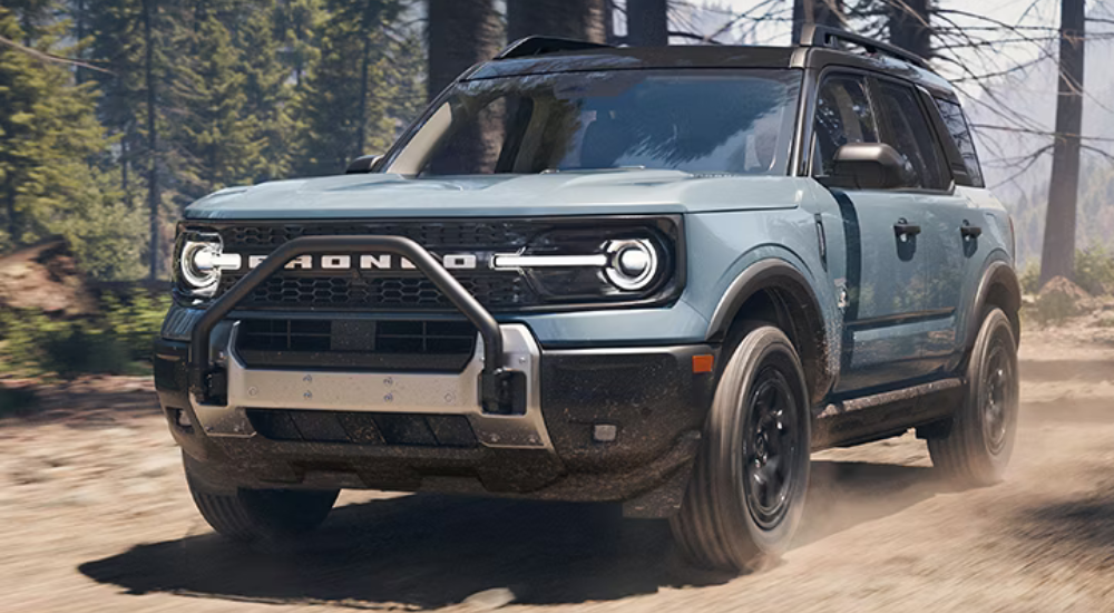 Blue 2025 Ford Bronco Sport Outer Banks Sasquatch driving down a trail