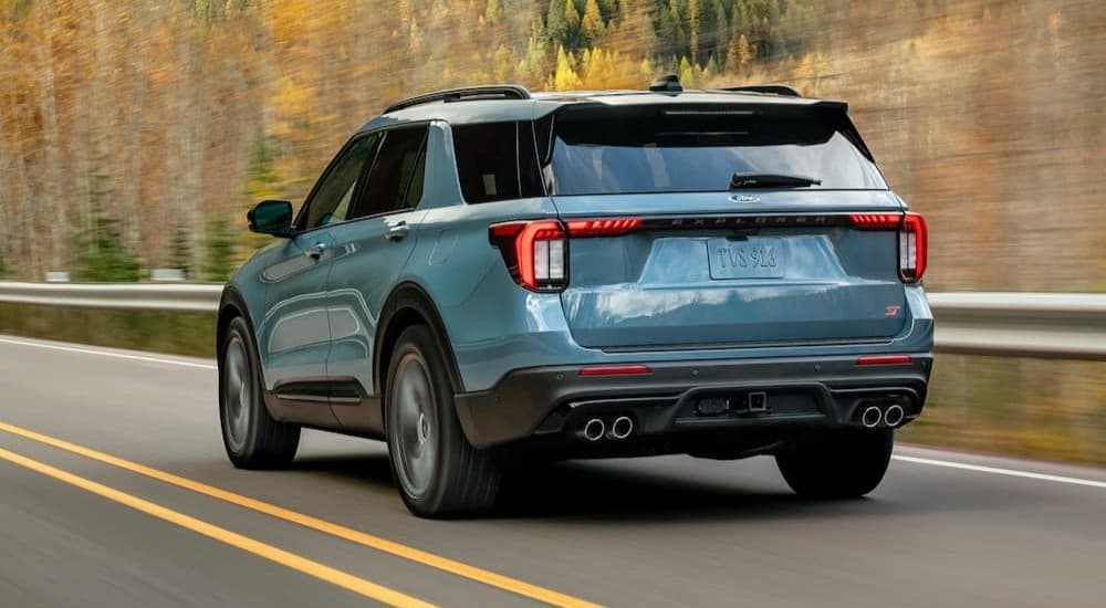 A blue 2026 Ford Explorer for sale driving on a highway.