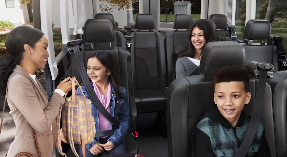 Children sitting in the rear area of a 2026 Ford Transit.