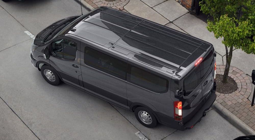 A gray 2026 Ford Transit parked in a city.