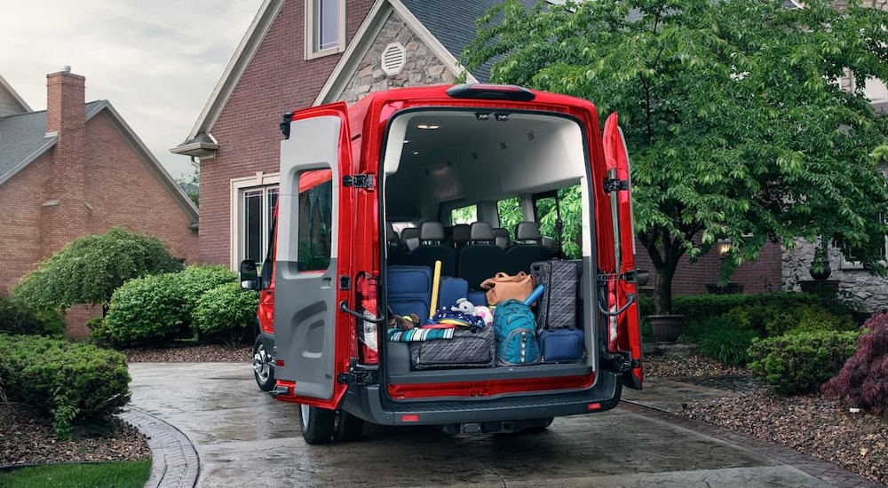 The open rear doors on a red 2026 Ford Transit.