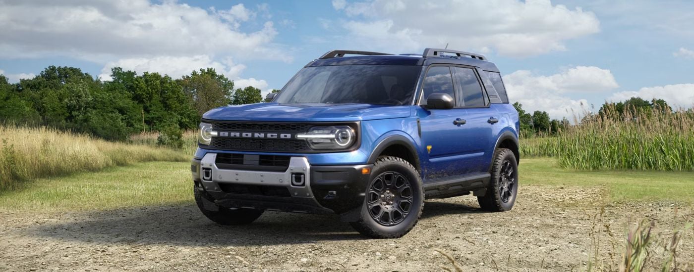 Blue 2026 Ford Bronco Sport parked in a grassy field.