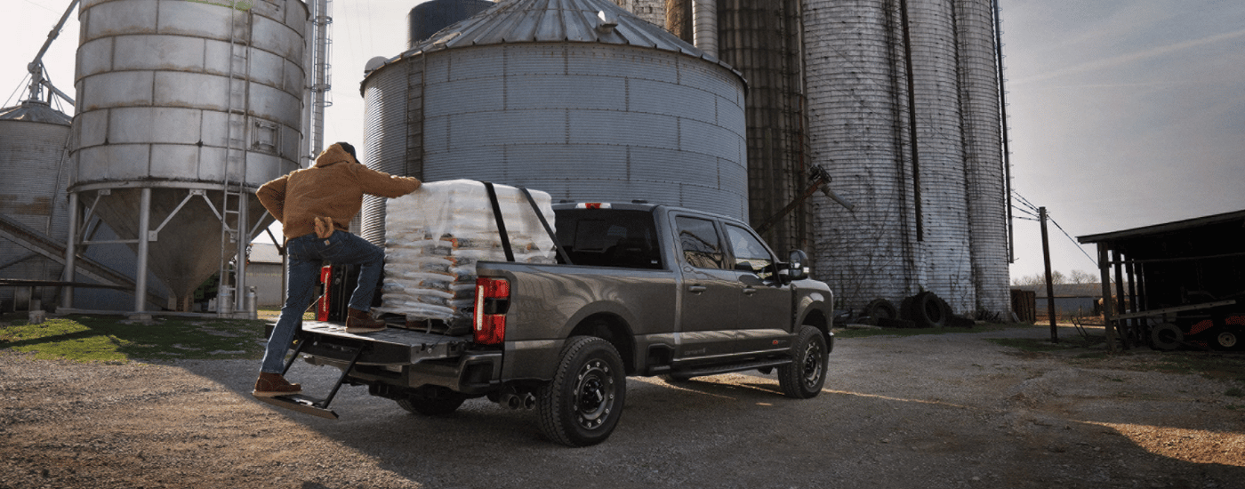 Grey 2026 Ford F-250 SD Carhart Edition with the bed being loaded