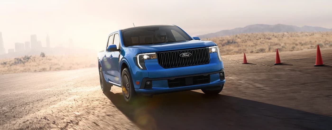 A blue 2025 Ford Maverick LOBO driving on a track.